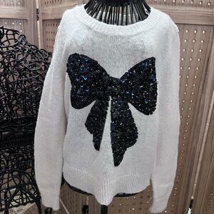 Girl size 8 white sweater with black sparkly bow.
